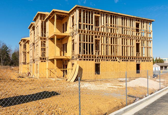 construction zone secured with a temporary fence, marked with warning signs in Sugar Land, TX